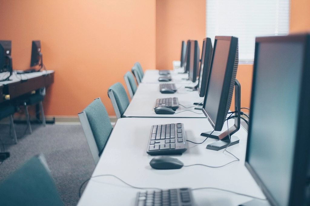 A row of desktop workstations in a computer lab